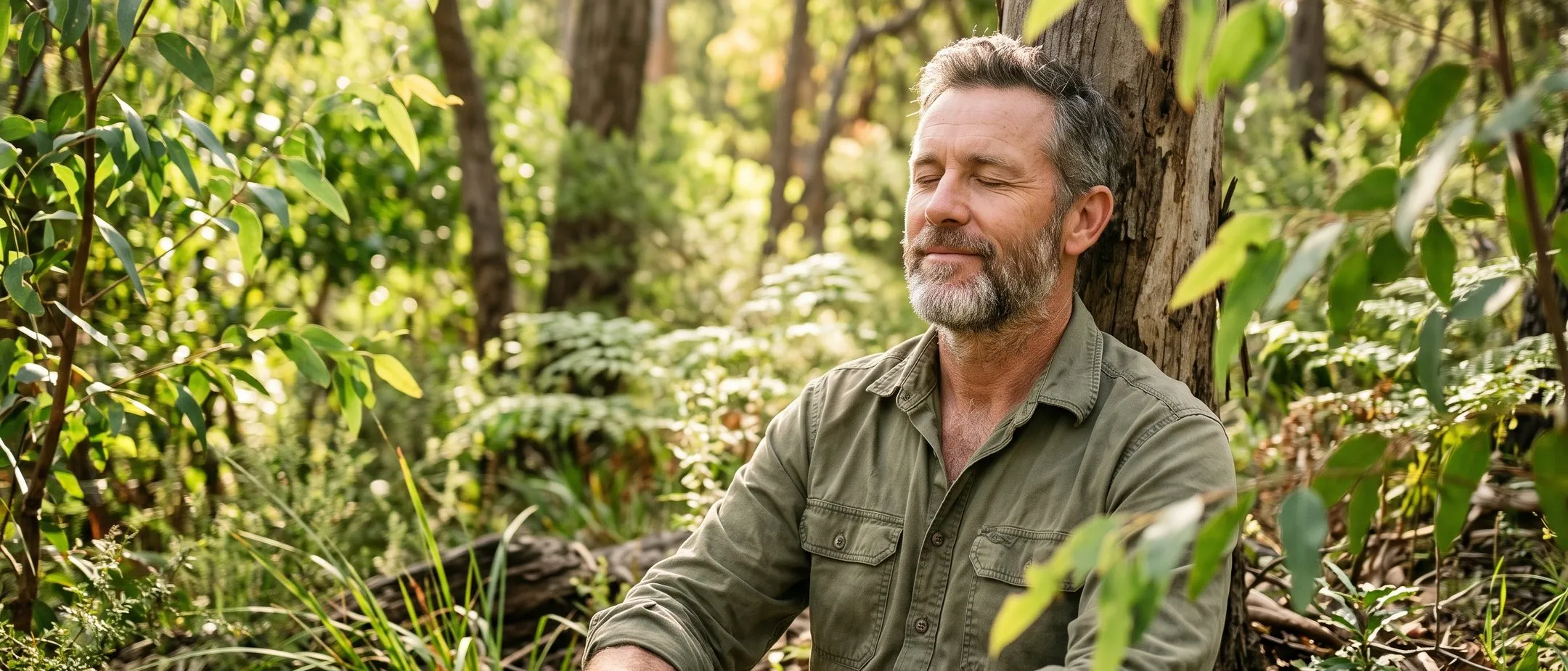 Relaxed man outdoors, calm after hypnotherapy for anxiety